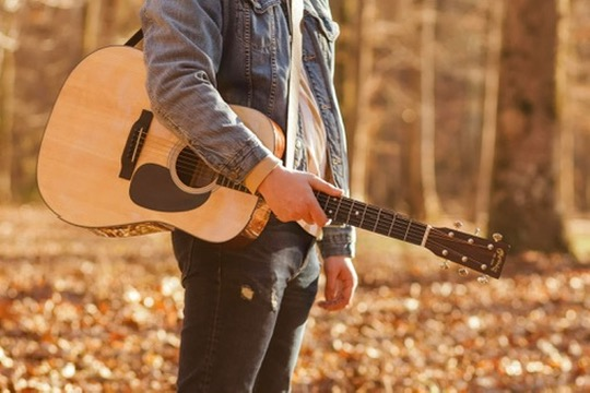Close-up of Daniel's acoustic guitar